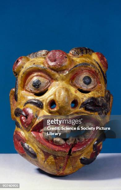 This polychrome wooden mask represents Heraya, the soldier from the kolam play, with his face covered in sores and leeches. It was worn for healing...