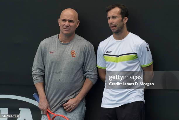 Andre Agassi and Radek Stepanek watch their player Novak Djokovic during practice on day six of the 2018 Australian Open at Melbourne Park on January...