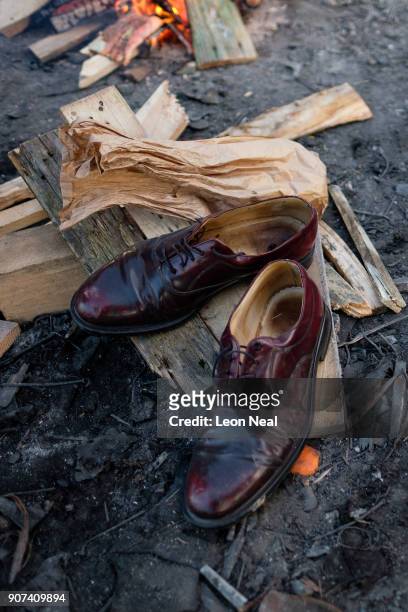 Man's shoes are left to dry out near a campfire on an industrial estate on January 19, 2018 in Calais, France. During a visit to the UK by French...