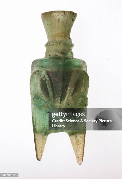 Four-footed molar tooth glass bottle found at Hebron in Jordan. The shape suggests that there was a metal original for the type, with the feet...