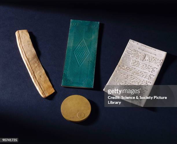 This selection of objects consists of an unfinished ivory imitation comb, a roughly circular disc, a lithographic block stained green on one surface...