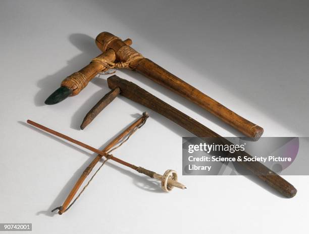 Primitive hand axe , fragging stick and bow drill . The reversible axe on adze, dating from c 2000 BC has a greenstone blade that is tied to the...