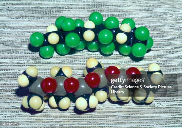 Two models showing the molecular structure of the basic unit of a synthetic rubber containing fluorine and silicon . Germany produced the first...