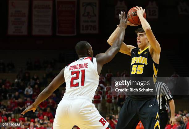 Luka Garza of the Iowa Hawkeyes is defended by Mamadou Doucoure of the Rutgers Scarlet Knights during the first half of a game at Rutgers Athletic...