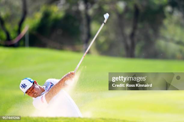 Hideto Tanihara of Japan plays his fourth shot on the 13th hole during round three of the Abu Dhabi HSBC Golf Championship at Abu Dhabi Golf Club on...