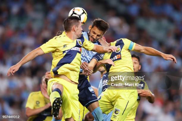 Milos Ninkovic of Sydney FC is challenged by Jake McGing and Alan Baro of the Mariners during the round 17 A-League match between Sydney FC and the...