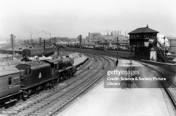 British Railways Class 5 4-6-0 steam locomotive No 45498 at Rutherglen Station with a passenger train bound for Balloch. The Class 5 locomotive was...