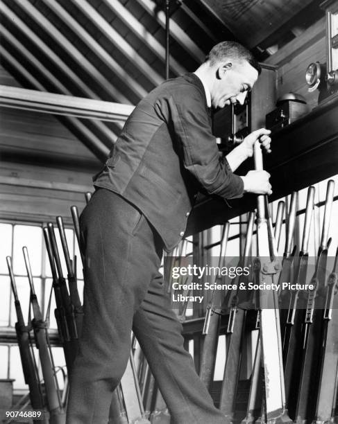 Signal box interior, January 1937. LMS signalman working the signal lever in the cabin at Chorley Station, Lancashire.