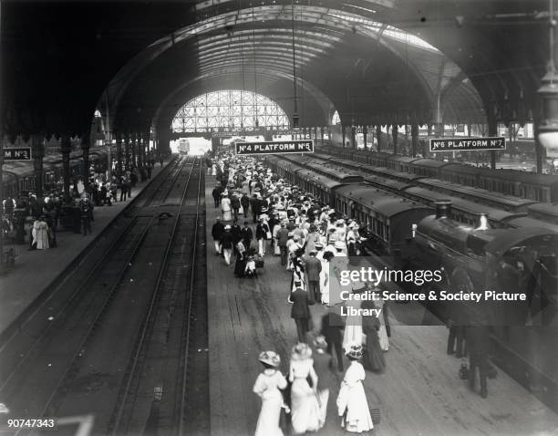 Great Western Railway official photograph showing crowds on platforms 4 and 5, waiting for the train to take them to the Henley rowing regatta. A...
