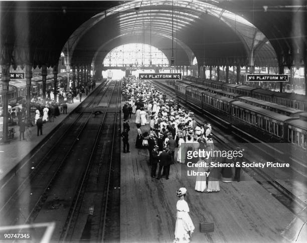 Crowds on platforms 4 and 5 at Paddington station, waiting for the train to take them to the Henley rowing regatta, 2 July 1908. A Saint class 4-6-0...