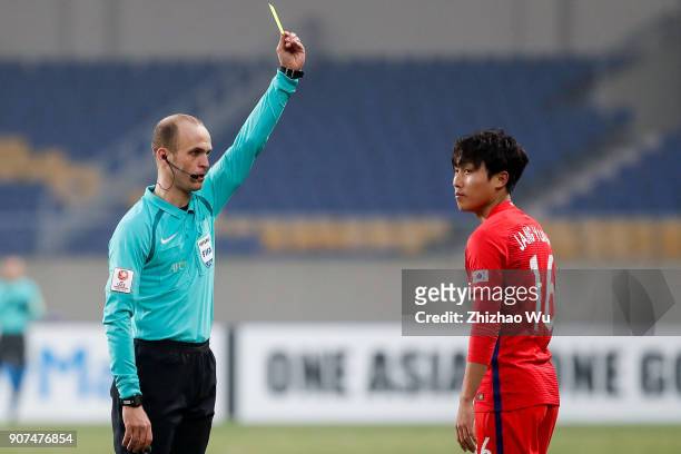 Adham Mohammad Makhadmeh referee of Jordan gives yellow card to Jang Yunho of South Korea during AFC U23 Championship Quarter-final between South...