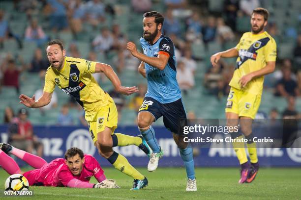 Alex Brosque of Sydney FC runs the ball past keeper Ben Kennedy and defender Joshua Rose of the Central Coast during the round 17 A-League match...