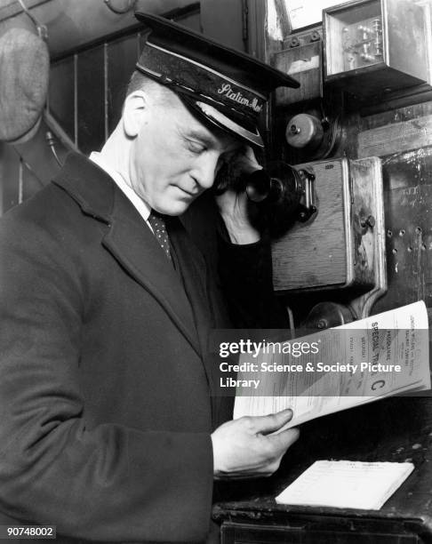 Stationmaster using the telephone to discuss train movements, Chorley Station, Lancashire, January 1937. London, Midland and Scottish Railway...