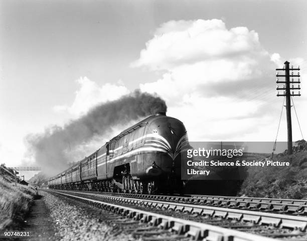London, Midland & Scottish Railway Coronation Pacific class steam locomotive No 6220 'Coronation' climbing toward Shap Summit with a streamlined...