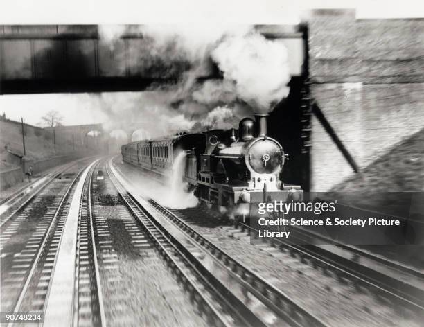 The London & North Western Railway locomotive Jeanie Deans picking up water at Bushey Troughs in 1899. The image is a still from a film made by the...