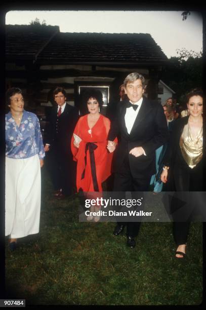 Actress Elizabeth Taylor and her husband Senator John Warner arrive at a party June, 1980 in Washington, DC. Taylor has married seven different men...