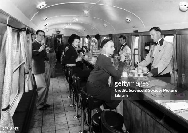Photograph by Fox Films for the 1939 'Holiday Haunts' brochure. The buffet car provided a new informal way of eating on trains, with passengers able...