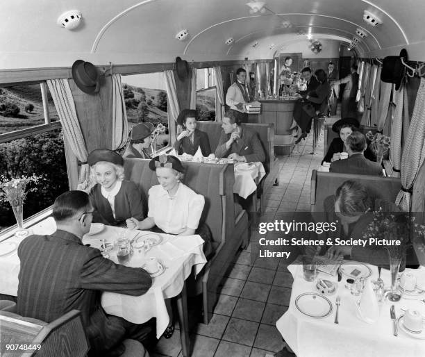 Photograph by Fox Films for the 1939 'Holiday Haunts' brochure. The buffet car provided a new informal way of eating on trains, with passengers able...