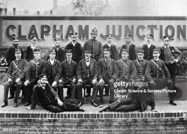 London, Brighton & South Coast Railway staff, Clapham Junction station, London, August 1889. Staff include a stationmaster , a policeman, guards and...