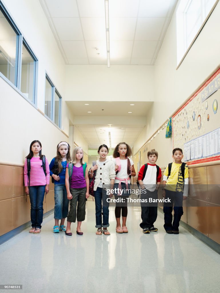 Group of young students in hallway of school