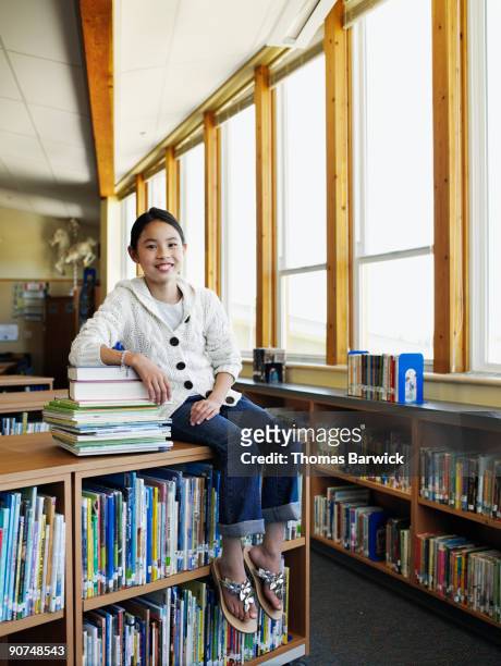 young female student sitting in library - banbossy stock pictures, royalty-free photos & images