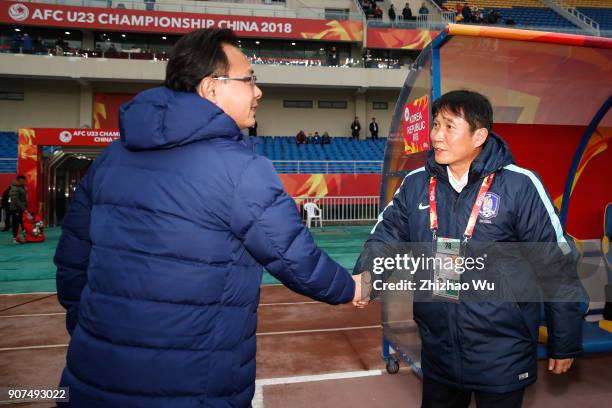 Kim Bong Gil coach of South Korea shakes hand with Ong Kim Swee coach of Malaysia during AFC U23 Championship Quarter-final between South Korea and...