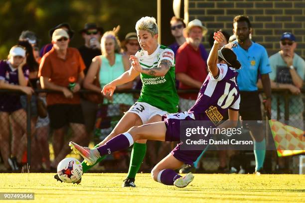 Michelle Heyman of Canberra United passes the ball past Amanda Frisbie of Perth Glory during the round 12 W-League match between the Perth Glory and...