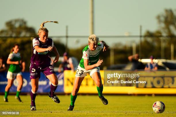 Michelle Heyman of Canberra United leads in front of Kim Carroll of Perth Glory during the round 12 W-League match between the Perth Glory and...