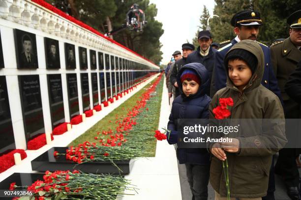 Azerbaijanis visit the Alley of Martyrs, a cemetery and memorial dedicated to those killed by Soviet troops during the 1990 Black January crackdown,...