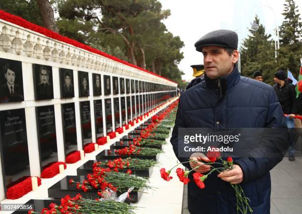 Azerbaijanis visit the Alley of Martyrs, a cemetery and memorial dedicated to those killed by Soviet troops during the 1990 Black January crackdown,...