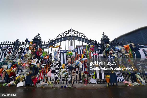 Floral tributes along with shirts and scarves left by West Bromwich Albion Fans in memory of Cyrille Regis on the Jeff Astle gates at The Hawthorns...