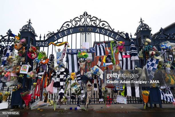 Floral tributes along with shirts and scarves left by West Bromwich Albion Fans in memory of Cyrille Regis on the Jeff Astle gates at The Hawthorns...