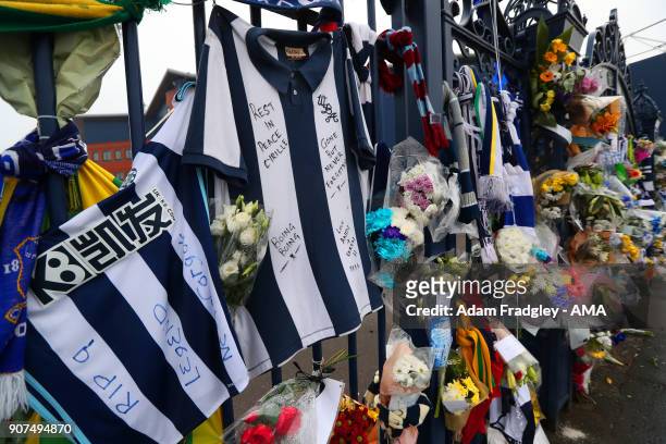 Floral tributes along with shirts and scarves left by West Bromwich Albion Fans in memory of Cyrille Regis on the Jeff Astle gates at The Hawthorns...