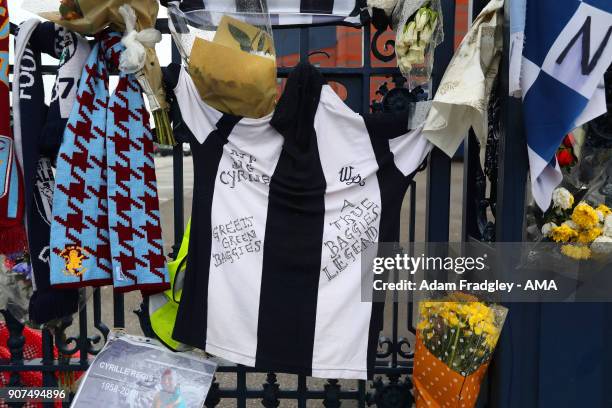 Floral tributes along with shirts and scarves left by West Bromwich Albion Fans in memory of Cyrille Regis on the Jeff Astle gates at The Hawthorns...