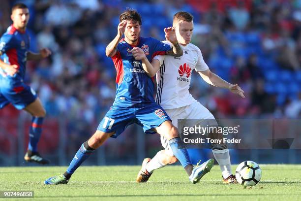 Patricio Rodriguez of the Jets contests the ball with his Phoenix opponent during the round 17 A-League match between the Newcastle Jets and...