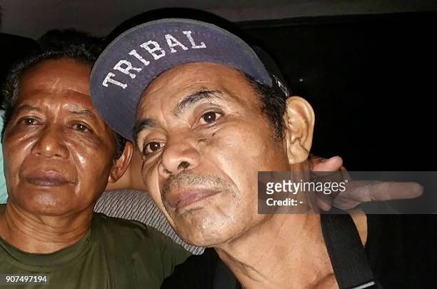 This photo taken on January 19, 2018 shows two Indonesian men who were freed after being held hostage for more than a year, in the town of Jolo, Sulu...