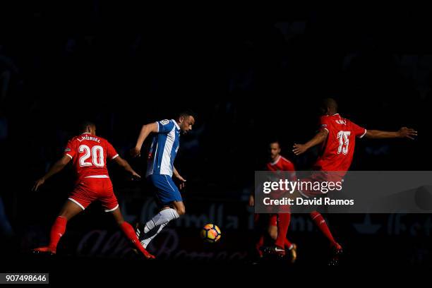 Javi Fuego of RCD Espanyol competes for the ball with Luis Muriel and Steven N'Zonzi of Sevilla FC during the La Liga match between Espanyol and...