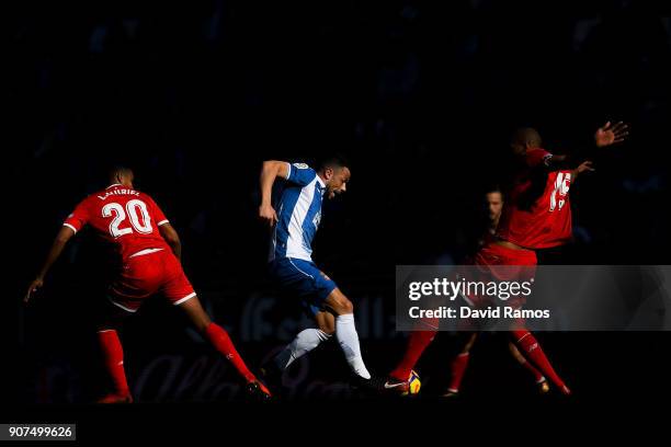 Javi Fuego of RCD Espanyol competes for the ball with Luis Muriel and Steven N'Zonzi of Sevilla FC during the La Liga match between Espanyol and...