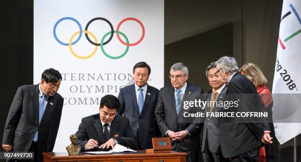 PyeongChang 2018 Olympics president Lee Hee-beom looks on as North Korea's Sports Minister and Olympic Committee president Kim Il Guk signs, and...