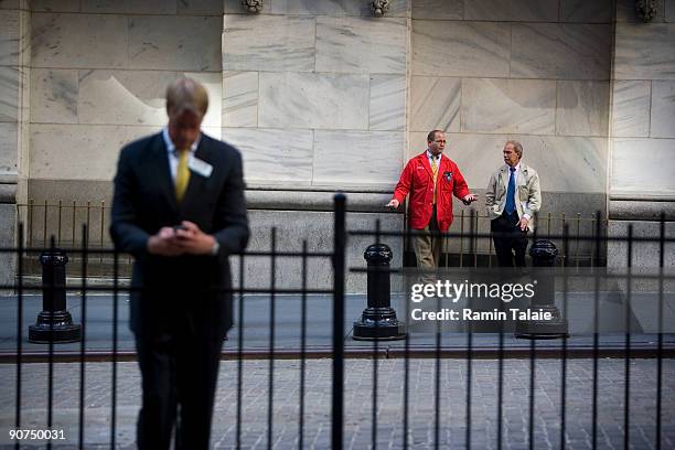 Traders take a break outside of the New York Stock Exchange on September 14, 2009 in New York City. President Obama gave a major speech on the state...