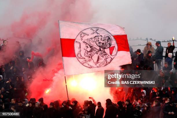 Ajax Amsterdam supporters hold a flag of the club during the public training in Amsterdam, on January 20 in the run-up to the match against Feyenoord...