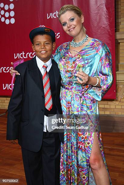 Actress Anne-Sophie Briest holds her Victress Award with her son Jahmar Walker at the Victress Day Gala 2009 on September 14, 2009 in Berlin, Germany.