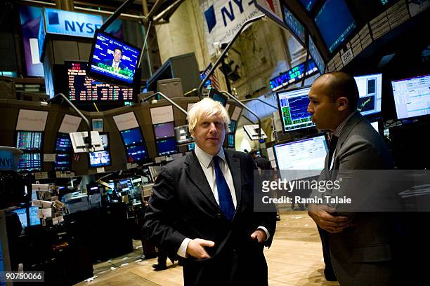 Boris Johnson the mayor of London, speaks with Fabian Caceres, a trader on the floor of the New York Stock Exchange after ringing the closing bell at...