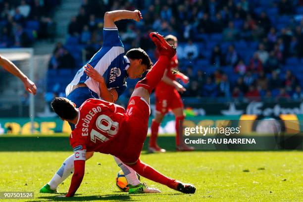 Espanyol's Spanish defender Javier Lopez challenges Sevilla's Spanish defender Sergio Escudero during the Spanish league football match between RCD...