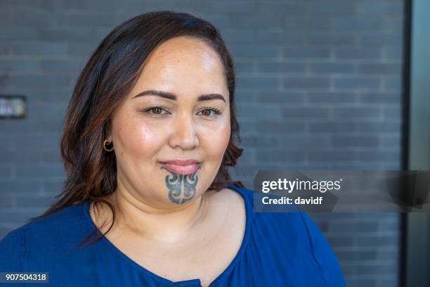 portrait of a maori woman with a face tattoo or moko - maori tradition stock pictures, royalty-free photos & images