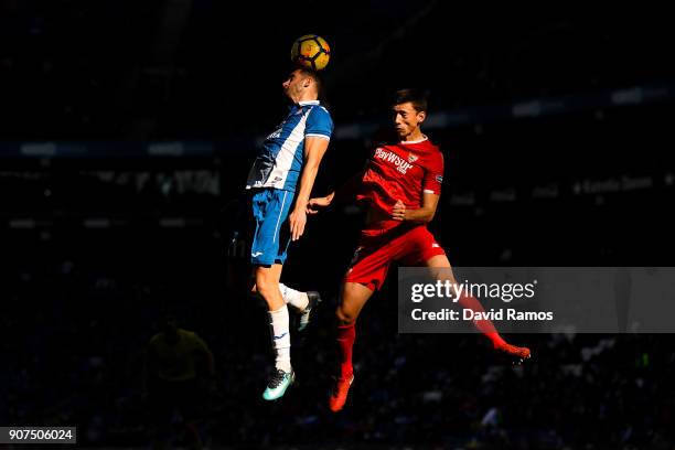 Leo Baptistao of RCD Espanyol competes for a high ball with Clement Lenglet of Sevilla FC during the La Liga match between Espanyol and Sevilla at...