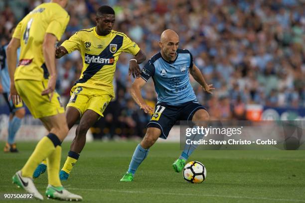 Adriam Mierzejewski of Sydney FC is challenged by Mariners Kwabena Appiah-Kubi during the round 17 A-League match between Sydney FC and the Central...