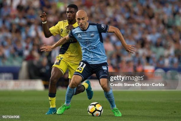 Adriam Mierzejewski of Sydney FC is challenged by Mariners Kwabena Appiah-Kubi during the round 17 A-League match between Sydney FC and the Central...