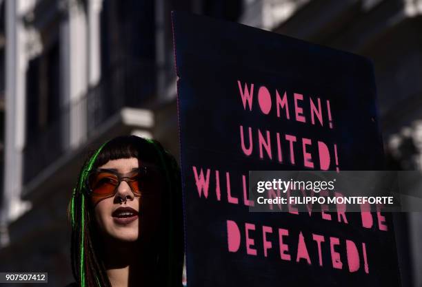 Anna Lou Castoldi, daughter of Italian actress Asia Argento, holds a banner reading "Womwn united will never be defeated" during Rome Resists...