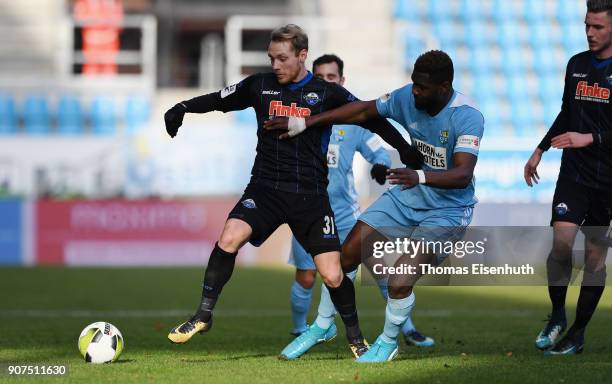 Emmanuel Mbende of Chemnitz is challenged by Ben Zolinski of Paderborn during the 3. Liga match between Chemnitzer FC and SC Paderborn 07 at...